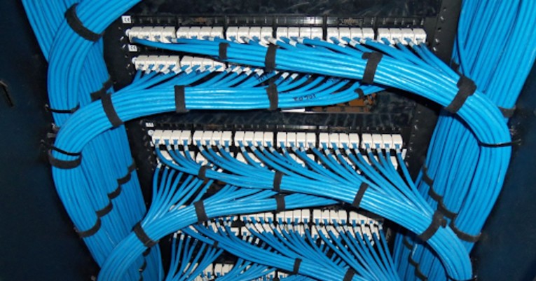 Blue Ethernet cables connected to a patch panel