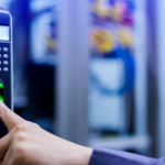 Person using a fingerprint scanner for secure access control system.