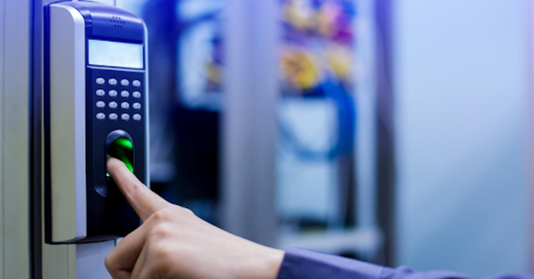 Person using a fingerprint scanner for secure access control system.